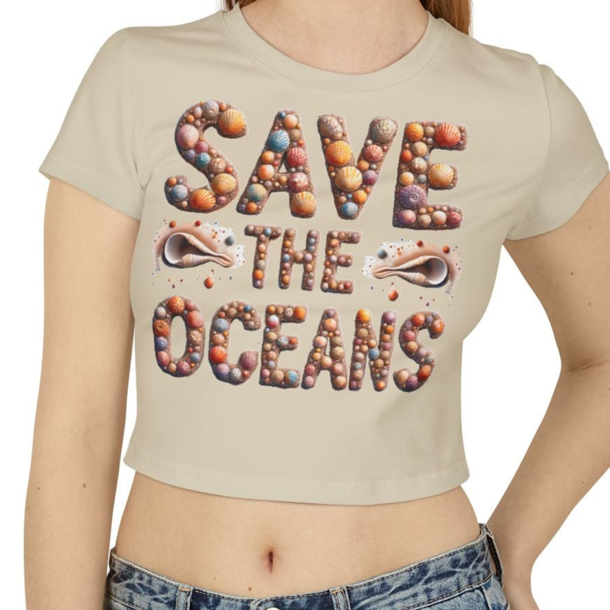 'Save The Oceans' spelled out in seashells on a baby tee - sand