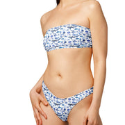 Woman wearing a blue and white patterned bikini on a white background