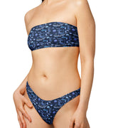 Woman wearing a blue fish-pattern bikini on a NAVY background